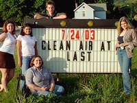 Reality Check members unveil Clean Air sign on Rt 13 at Dey St., Ithaca