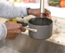 Filling a cooking pot with water