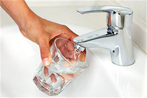 Filling a glass with tap water