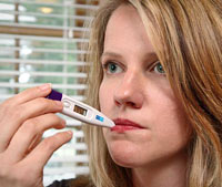 Checking for fever using a thermometer. PHOTO: James Gathany (CDC, 2005)