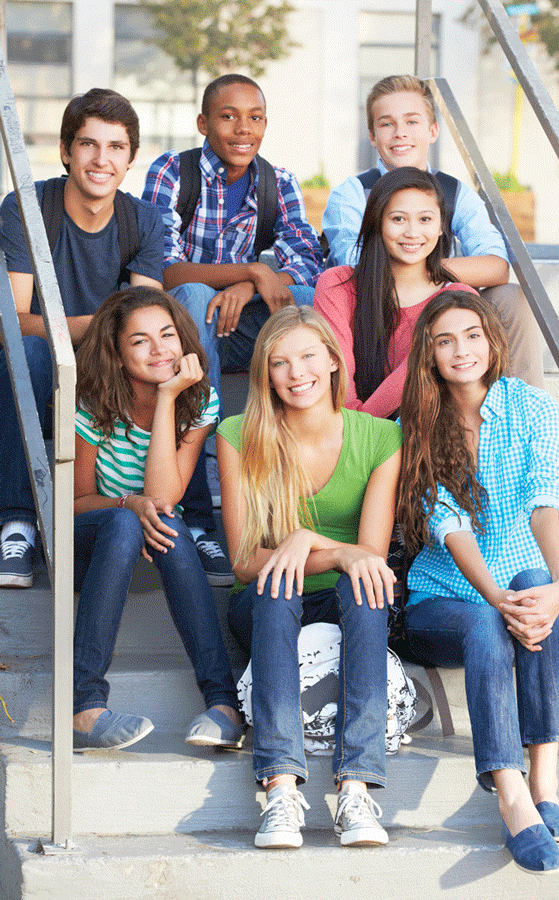 Teens sitting on outdoor stairs at school